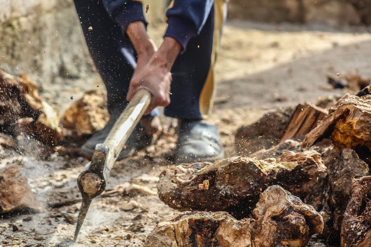 Person Smashing Pick Axe On Ground